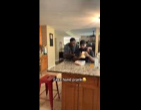 Two men pranks friend arm on shoulder