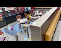 Pigeons eats leftover food inside the restaurant