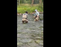 Man shows fish caught in the river for photoshoot