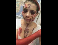 Woman does special effects makeup, pulls glass shard out of her bloody face