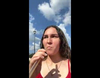 Girl red shirt shoots boba out of straw 