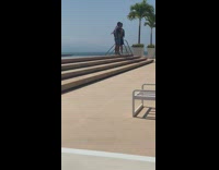 Guy blue unbuttoned shirt stairs pool tree