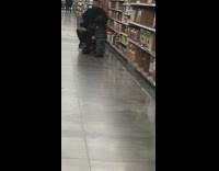 Boy holds onto mobility scooter grocery store 