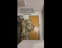 Guy changes outfit into army clothes 