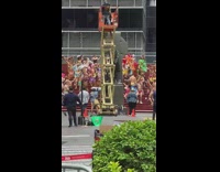 Group of people in colorful clothing dance on stairs 