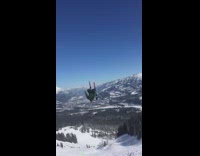 Skiier does flip in the air and lands