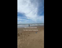 Dad carries baby runs around the beach