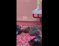 two girls lay on sprinkles bed