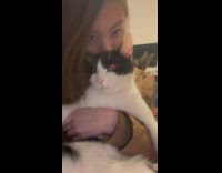 Lady Snuggles with Cat as Grumpy Cat Watches