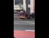 Trash burning on the sidewalk