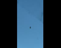 Guy driving sees object floating in sky 