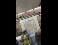 Military uniform black gas mask subway train