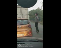 Guy dancing outside his car in standstill traffic