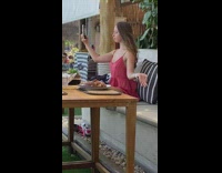 Woman in red dress yoga pose at a restaurant Part 2