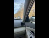 Car with hood up driving on highway