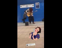 Guy plays guitar girl dances subway station 