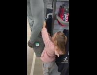 Toddler daughter pulling down pants of mannequin