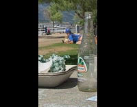 Man blue shirt lie down chihuahua dog park