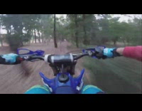 Guy drive motorcycle wheelie between trees stunt