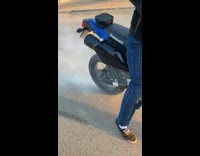 Guy revs motorcycle and falls off bike