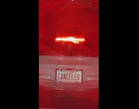 White custom vanity plate says canceled car 