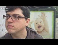 Guy warn friend about baby poster behind