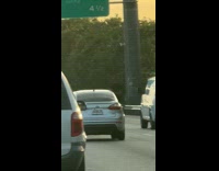 Man half body out of moving car