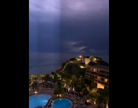 Lightning strike flashes nonstop beach resort nighttime