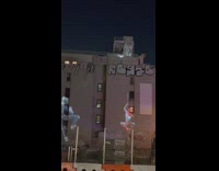 Spiderman projections climb up wall 