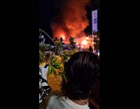 Firemen spray water to burning yacht boat