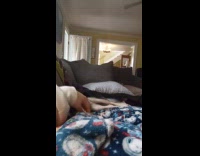 Girl on sofa grab paw of dog