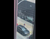 Man with colorful jacket tiktok dance beside the car