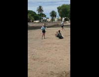 Woman hat blue shirt lean sideways castle