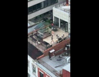 Shirtless guy practice juggling at rooftop