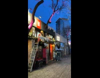 Fake snow machine and instrument playing outside restaurant.