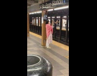Woman plays shofar horn in station 