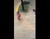 Two girls lay pose flood water street