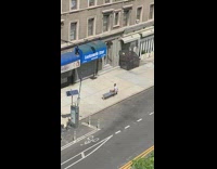 Guy straddles bench self timer photos sidewalk 