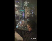 Guy looking out of apartment building 