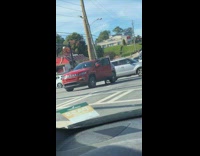 Woman leaves car middle of intersection street