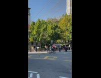 Man balances trashcan while on bike