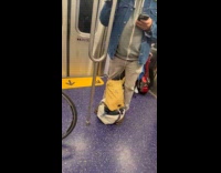 Man in train earphones wires not plugged