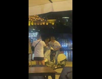 Man in white shirt rides and poses on the scooter