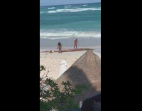 Guy red thong hands behind head beach