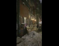 Girl watches guy play piano on sidewalk 