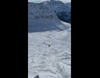 orange jacket ski back flip landed