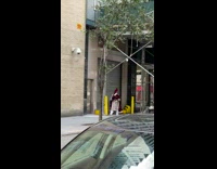 Guy walking down sidewalk wears red and white dress costume 