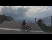 kid in skatepark slow mo bike face plant