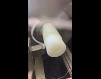 Machine spins shaves plastic white stick day 