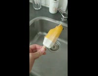 Orange white popsicle stick with second stick 